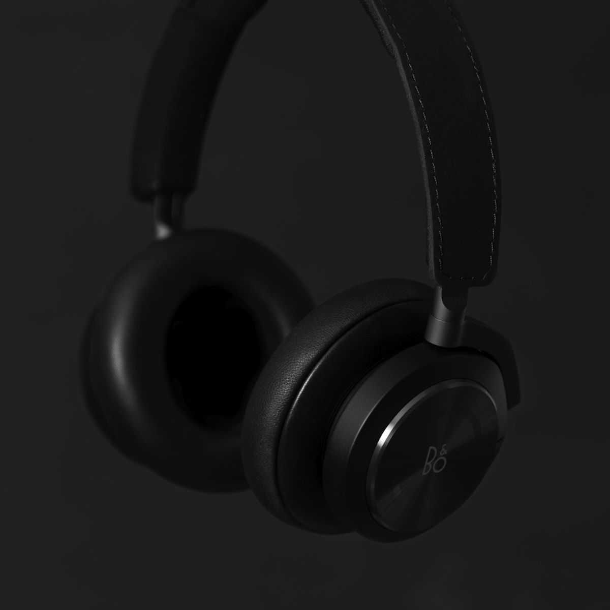 Matte black over-ear HELM headphone, side profile on grey background
