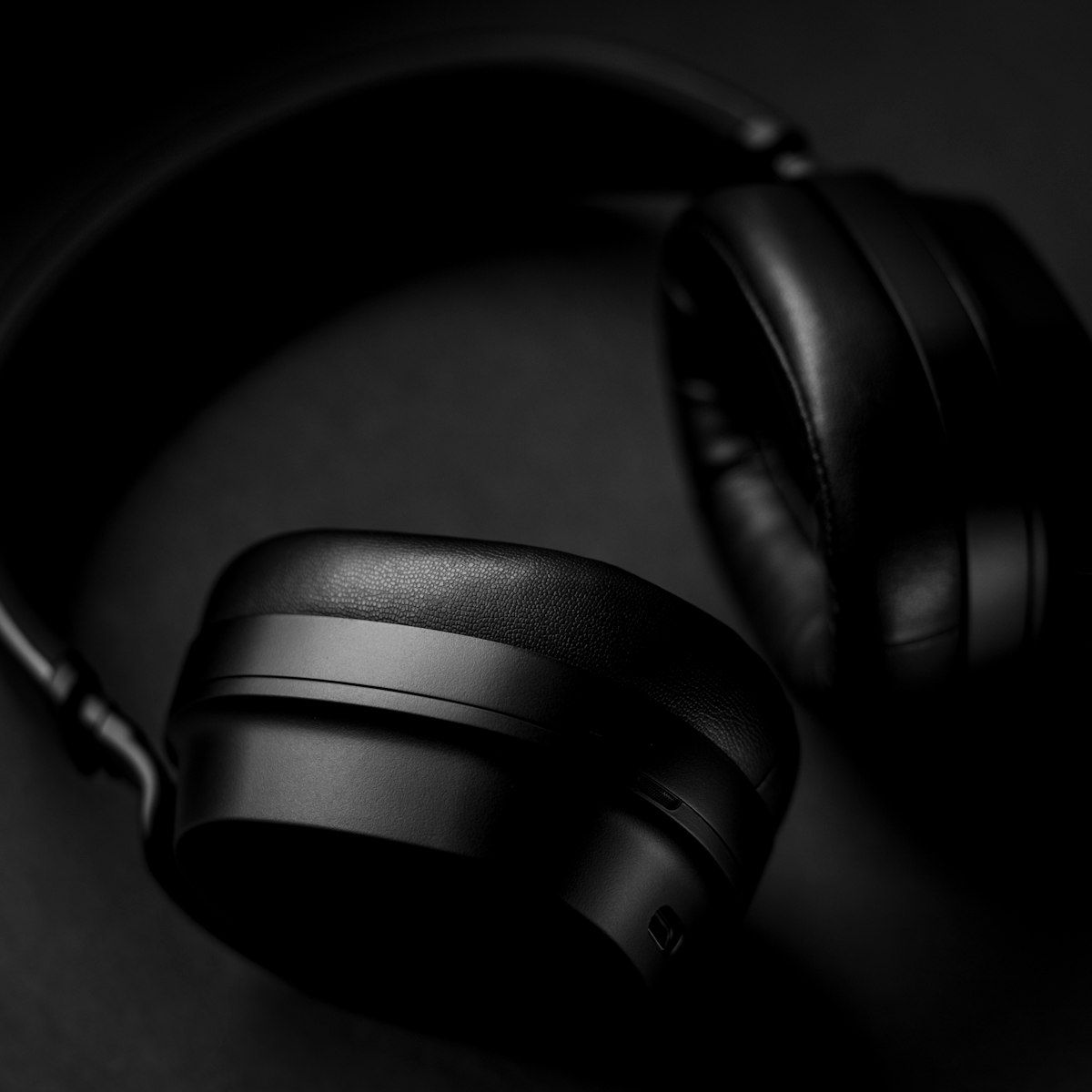 Black HELM headphones in close moody dark lighting